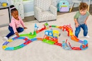Lifestyle image of two children playing with the VTech My First Motorized Train Set