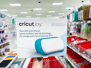 hand holding cricut joy box in aisle
