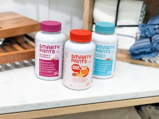 three vitamin bottles sitting on shelf
