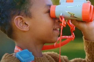 a boy using toy binoculars