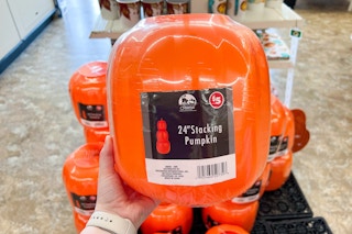 person holding a pack of stacking pumpkins