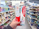 hand holding colgate oral care items in walgreens