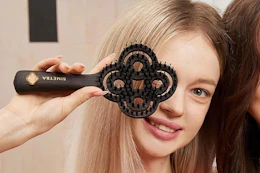 a girl holding a hair brush