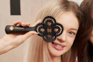 a girl holding a hair brush