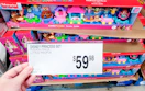 hand holding price signage in front of fisher price toy set