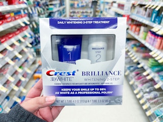hand holding crest two step toothpaste in walgreens