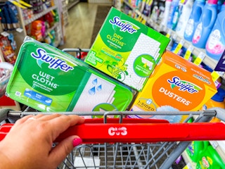 person pushing a cart with swiffer refills in it