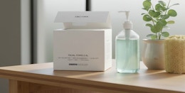 a pack of face towels on a wooden table next to a bottle of soap