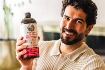 amn holding bottle of multivitamins