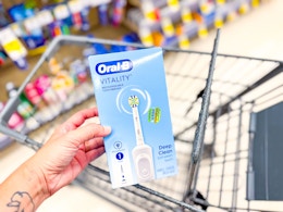 hand holding oral-b floss action toothbrush