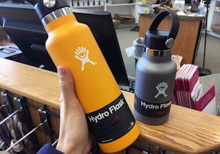 someone holding up a hydro flask bottle