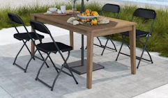 chairs at a patio table on a beach