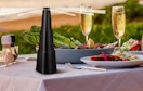 a fly fan on a table with food outside 