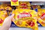 hand holding a bag totinos pizza rolls