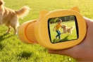 Kid holding the GMYGBY Handheld Digital Mini Microscope for Kids: 1000X 4K.