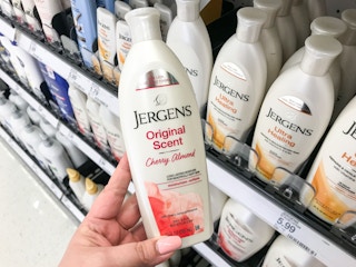 hand holding a bottle of jergens lotion at target
