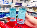 2 neutrogena clear pore astringent bottles sitting on top a target cart