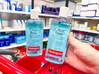 2 neutrogena clear pore astringent bottles sitting on top a target cart