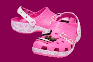 pink and white Barbie crocs on a maroon background