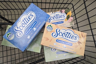 multiple boxes of scotties tissues in a cart