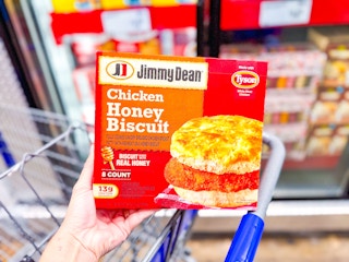 hand holding a box of jimmy dean biscuits