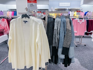 plus-size sweater cardigans hanging on a rack