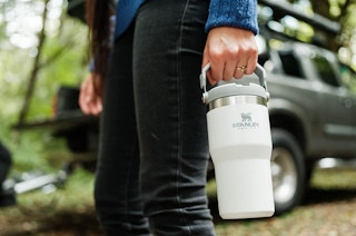 A person holding a water bottle outside