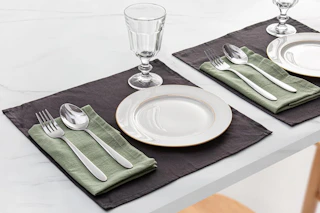 a silverware set and plates on a dinning room table