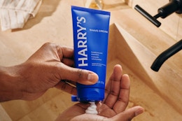 shaving creaming being put into palm of hand