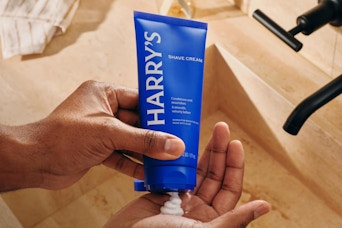 shaving creaming being put into palm of hand
