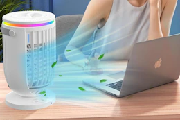 woman working next to portable air conditioner