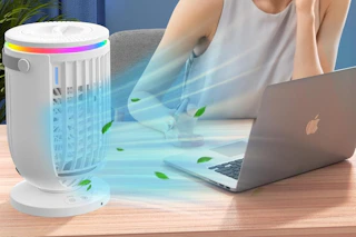 woman working next to portable air conditioner