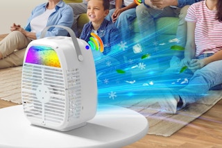 a mini air conditioner on a table in a living room with a family