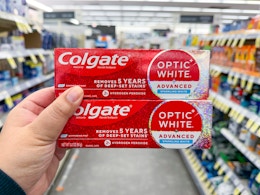 hand holding colgate toothpastes in walgreens