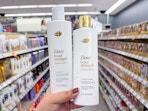 hand holding dove shampoos in walgreens