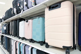 suitcases sitting on a target shelf