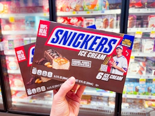 hand holding boxes of snickers ice cream bars