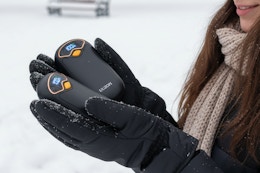 a woman holding hand warmers
