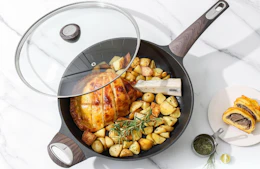 a frying pan with a lid with food inside