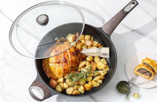 a frying pan with a lid with food inside