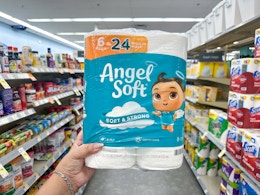 hand holding angel soft toilet paper in walgreens