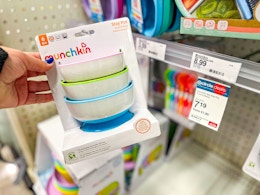 hand holding a munchin stay put bowl set at target