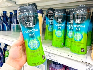 hand holding downy in-wash scent beads at target