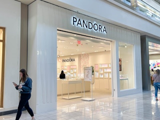 people walking outside a pandora jewelry store