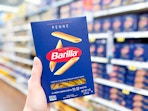hand holding a box of barilla pasta