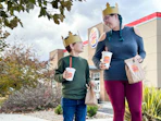 A mom and kid walking out of Burger King with drinks