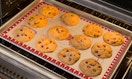 cookies on a baking sheet in an oven