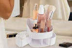 a rotating makeup organizer on a table