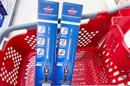 2 bissell featherweight lightweight vacuums in a cart
