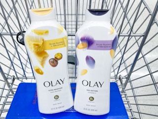 Two different types of Olay Body Wash sitting in a store cart.